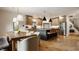 Open kitchen featuring a center island with seating, modern lighting, and stainless steel appliances at 1820 N 1100 E, Sheridan, IN 46069