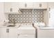 Well-organized laundry room with modern appliances, stylish backsplash, and plenty of cabinet space at 1820 N 1100 E, Sheridan, IN 46069