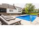 Backyard pool with tanning chairs, waterfall feature and view of the property at 1820 N 1100 E, Sheridan, IN 46069