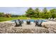 Outdoor living enhanced with a fire pit and pool with a waterfall feature and backyard playground at 1820 N 1100 E, Sheridan, IN 46069