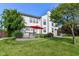 Expansive backyard featuring mature trees, a well-manicured lawn, a stone patio, and a red umbrella at 18967 Mill Grove Dr, Noblesville, IN 46062