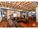 Unfinished basement featuring exposed beams, a large leather sofa, and a pool table at 18967 Mill Grove Dr, Noblesville, IN 46062