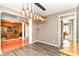 Elegant dining room featuring modern chandelier and doorway view to the living area at 18967 Mill Grove Dr, Noblesville, IN 46062