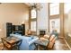 Bright, open living room featuring a fireplace, two-story windows, and comfortable seating arrangements at 18967 Mill Grove Dr, Noblesville, IN 46062