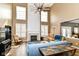 Bright living room with a soaring fireplace, lots of natural light, and a large ceiling fan at 18967 Mill Grove Dr, Noblesville, IN 46062