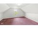 Cozy attic space with carpet, a window for natural light, and ample potential for customization at 20530 Victory Chapel Rd, Noblesville, IN 46060