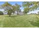 Large backyard with lush lawn and mature trees surrounding the property at 20530 Victory Chapel Rd, Noblesville, IN 46060