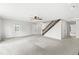Bright and airy living room featuring neutral walls, plush carpeting, a ceiling fan, and an inviting front door at 20530 Victory Chapel Rd, Noblesville, IN 46060