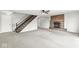Spacious living area with a cozy fireplace, wood stairs, and neutral carpeting for a comfortable atmosphere at 20530 Victory Chapel Rd, Noblesville, IN 46060
