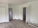 Bright bedroom featuring neutral walls, wooden floors, closet and doorway leading to another room at 243 Iowa St, Indianapolis, IN 46225