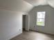 Bright bedroom featuring neutral walls, wooden floors, and a view from the window at 243 Iowa St, Indianapolis, IN 46225