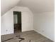 Bright bedroom featuring neutral walls, wooden floors, and a doorway leading to another room at 243 Iowa St, Indianapolis, IN 46225