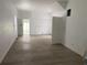 Bright living room featuring neutral walls, wooden floors, and a doorway leading to another room at 243 Iowa St, Indianapolis, IN 46225