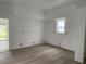 Bright living room featuring neutral walls, wooden floors, and a window for light at 243 Iowa St, Indianapolis, IN 46225