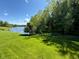 Lush backyard with mature trees and a serene lake view provide a peaceful and private outdoor space at 2925 N Country Club Rd, Martinsville, IN 46151
