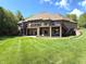 The backyard boasts a brick home with a walkout basement and multiple decks overlooking the lush green lawn at 2925 N Country Club Rd, Martinsville, IN 46151