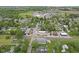 Aerial shot of town with green trees, and buildings including a high school and church at 30 N Depot St, New Palestine, IN 46163