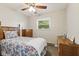 Relaxing bedroom with natural light, ceiling fan, and dresser at 30 N Depot St, New Palestine, IN 46163