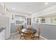 Cozy breakfast nook with round table, gray paneled walls and natural light at 30 N Depot St, New Palestine, IN 46163