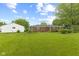 Charming brick ranch home featuring a spacious yard and detached two-car garage at 30 N Depot St, New Palestine, IN 46163