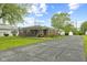 View of the home's exterior featuring a paved driveway, porch, and attached garage at 30 N Depot St, New Palestine, IN 46163