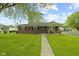 Charming single-story red brick home with a well-manicured lawn and covered front porch at 30 N Depot St, New Palestine, IN 46163