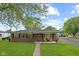 Charming single-story red brick home with a well-manicured lawn and covered front porch at 30 N Depot St, New Palestine, IN 46163