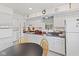 Modern kitchen area with white appliances, stylish decor and breakfast nook at 30 N Depot St, New Palestine, IN 46163