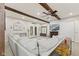 Open living room with comfortable seating, beam ceilings, fireplace and decor at 30 N Depot St, New Palestine, IN 46163