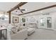 Spacious living room featuring a large sectional sofa, beam ceilings, and lots of decor at 30 N Depot St, New Palestine, IN 46163