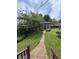 Backyard featuring a brick pathway, lush green grass, and a cozy outbuilding at 303 Walnut St, Greenfield, IN 46140