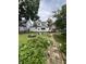 Landscaped backyard with a fire pit and walkway to the house's deck at 303 Walnut St, Greenfield, IN 46140
