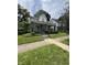 Charming two-story home with a covered porch and a well-manicured front lawn at 303 Walnut St, Greenfield, IN 46140