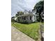 Two-story home featuring a covered porch, green lawn, and fenced yard at 303 Walnut St, Greenfield, IN 46140