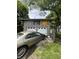 Two-car garage with sun and moon paintings, and a car in the driveway at 303 Walnut St, Greenfield, IN 46140
