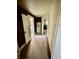 Hallway with vintage cabinet, brown walls, and access to rooms at 303 Walnut St, Greenfield, IN 46140