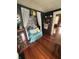Cozy sitting room with decorative cabinet, day bed and hardwood floors, in a vintage style at 303 Walnut St, Greenfield, IN 46140