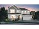 Charming two-story home featuring board and batten siding, a two-car garage, and professionally landscaped yard at 3080 Glasgow Pl, Danville, IN 46122