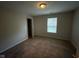 Bedroom featuring neutral paint, carpet, a window for natural light, and a door leading into the hall at 356 Seabreeze Cir, Avon, IN 46123