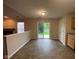 Open dining area with sliding glass doors and view to yard and patio, neutral paint and half wall to living space at 356 Seabreeze Cir, Avon, IN 46123