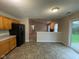 Spacious open floorplan between kitchen and living room, including vinyl flooring, neutral paint, and sliding glass doors at 356 Seabreeze Cir, Avon, IN 46123