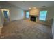 Bright living room with a fireplace, carpeted floors, and multiple windows at 356 Seabreeze Cir, Avon, IN 46123