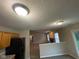 Spacious open floorplan between kitchen and living room, showing neutral paint, and carpeted floor at 356 Seabreeze Cir, Avon, IN 46123
