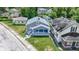 An elevated view shows a charming home surrounded by lush greenery in a quiet neighborhood at 3636 Crescent Ave, Indianapolis, IN 46208