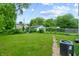 A spacious backyard, enclosed by a chain link fence, with a view of the surrounding greenery and neighborhood homes at 3636 Crescent Ave, Indianapolis, IN 46208