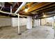 Unfinished basement with a concrete floor, block walls painted white, and exposed ceiling beams at 3636 Crescent Ave, Indianapolis, IN 46208