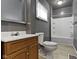 A full bathroom features a shower-tub combo, toilet, sink with vanity, and a window for natural light at 3636 Crescent Ave, Indianapolis, IN 46208