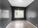 Cozy bedroom featuring gray walls, wood floors and a window offering natural light at 3636 Crescent Ave, Indianapolis, IN 46208