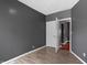 This is a bedroom with gray walls, wood flooring, and a door leading to another room at 3636 Crescent Ave, Indianapolis, IN 46208
