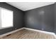 Bedroom featuring gray walls, light wood flooring, and a bright window at 3636 Crescent Ave, Indianapolis, IN 46208